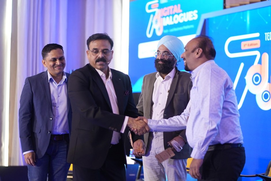 Naveen Budda on stage at an industry recognition event.